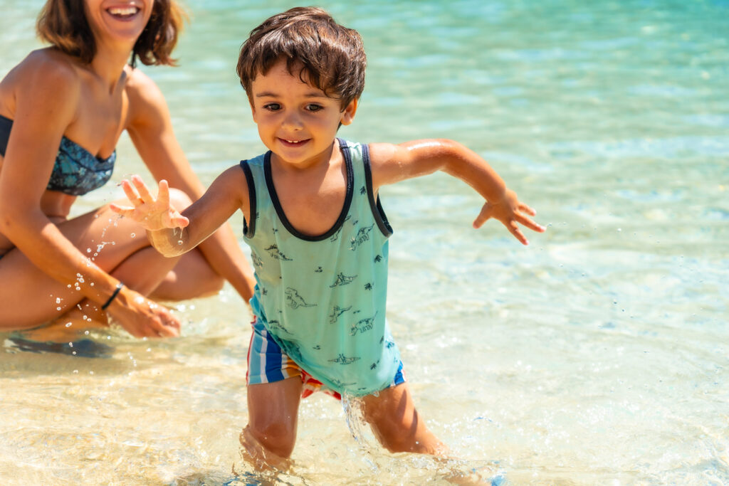 Mother And Son Enjoying The Summer On The Beach In Summer Of Paralia Mikros Gialos In The South Of The Island Of Lefkada. Greece.